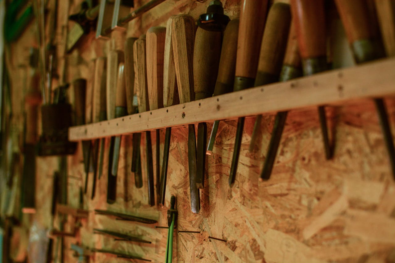 A collection of chisels and wood carving tools organized in a workshop setting.
